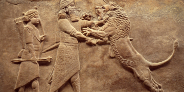 Assyrian wall relief, detail of panorama with royal lion hunt. Old carving from the Middle East history. Remains of culture of Mesopotamia ancient civilization. Amazing Babylonian and Sumerian art.