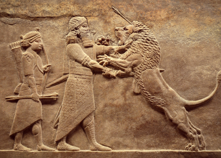 Assyrian wall relief, detail of panorama with royal lion hunt. Old carving from the Middle East history. Remains of culture of Mesopotamia ancient civilization. Amazing Babylonian and Sumerian art.